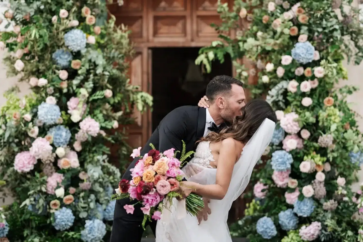Luxury Sicilian wedding reception with floral tables and historic garden setting